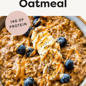 Bowl of Peanut Butter Oatmeal topped with chia seeds, peanut butter, banana and blueberries.
